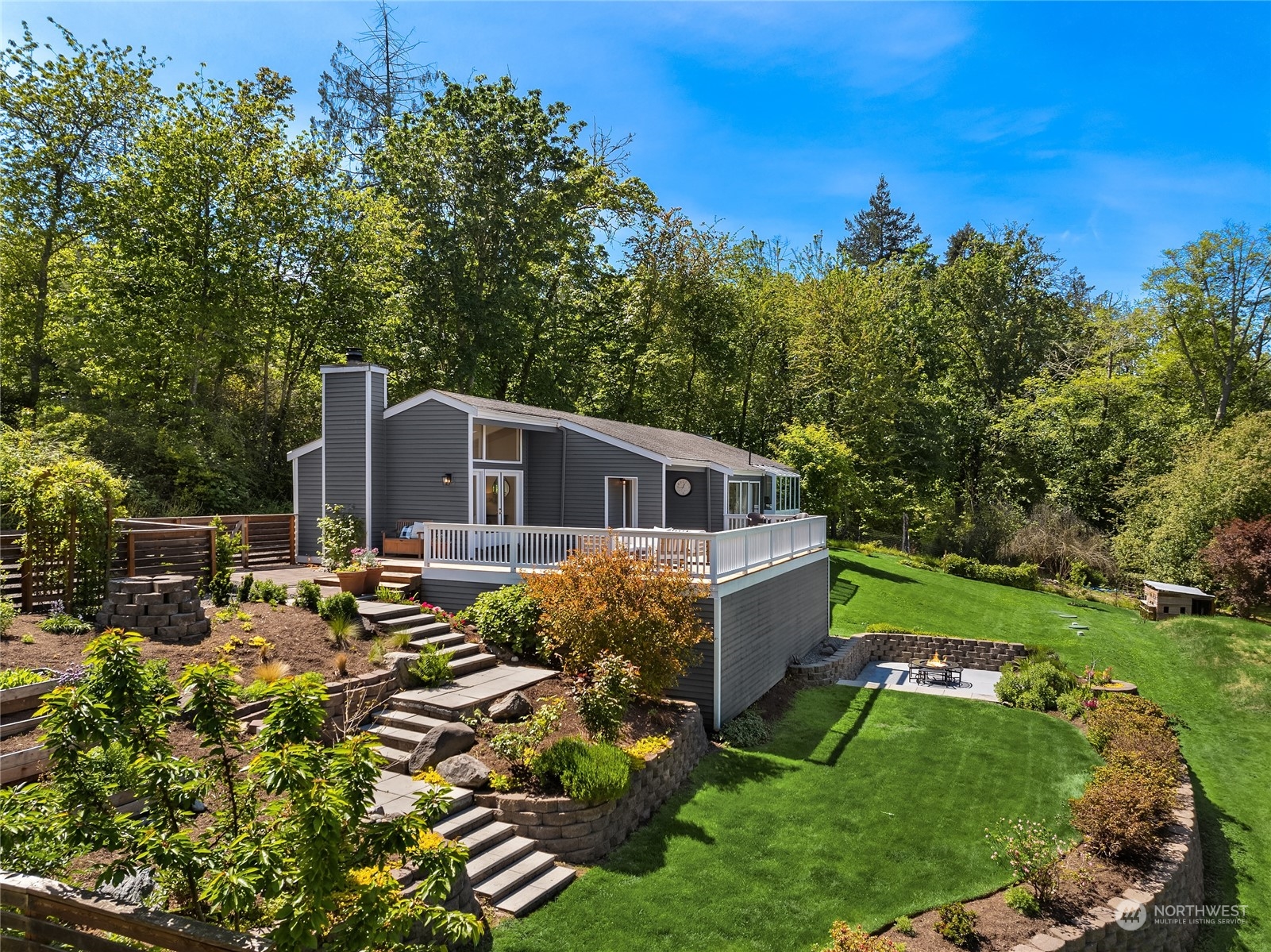 6024 Rose Loop Northeast Bainbridge Island, WA 98110 - Photo 32 of 40 a view of a house with backyard sitting area and garden