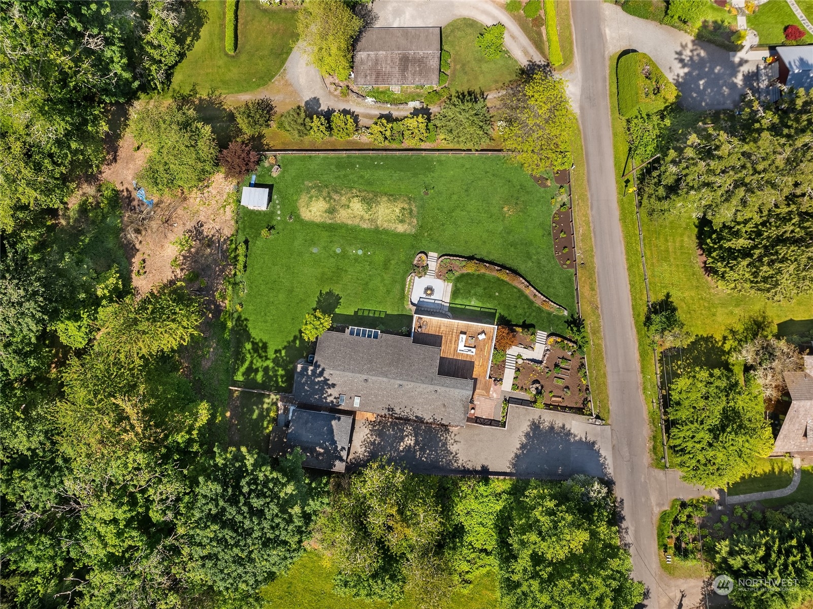 6024 Rose Loop Northeast Bainbridge Island, WA 98110 - Photo 37 of 40 an aerial view of a house with a yard and lake view
