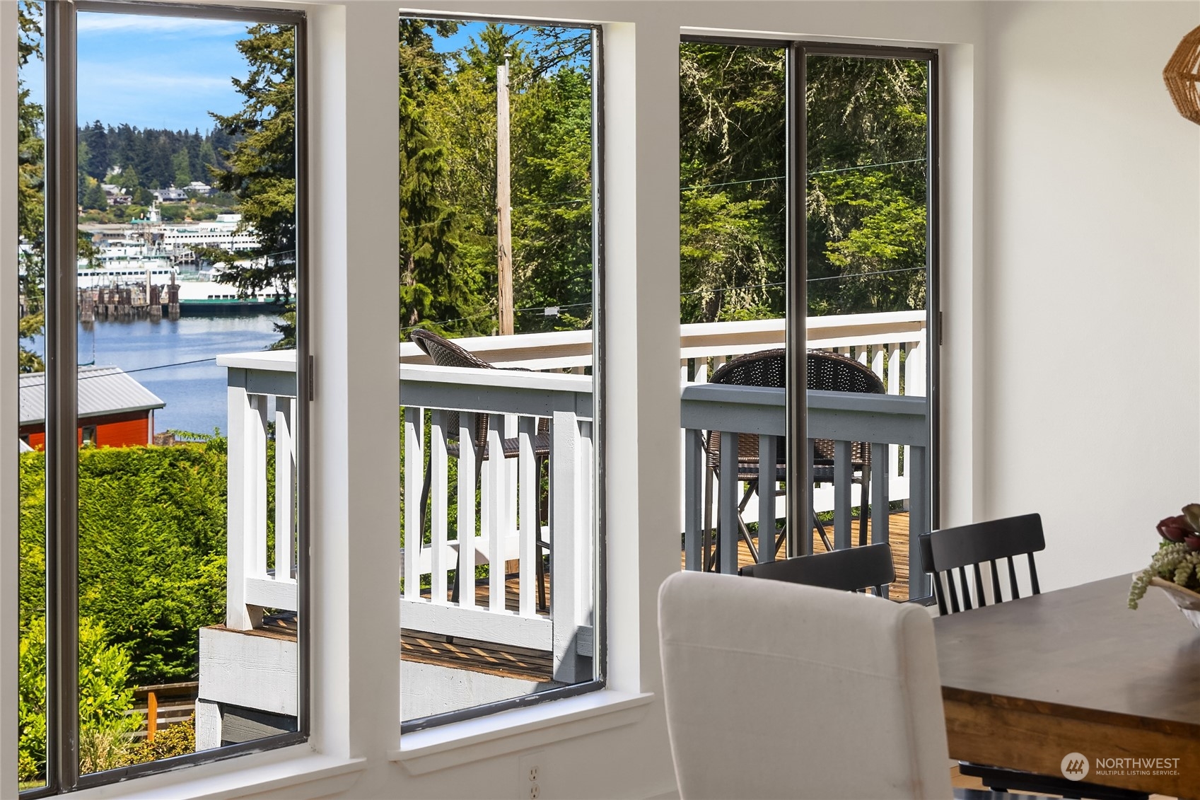6024 Rose Loop Northeast Bainbridge Island, WA 98110 - Photo 6 of 40 a view of a porch with a table and chairs