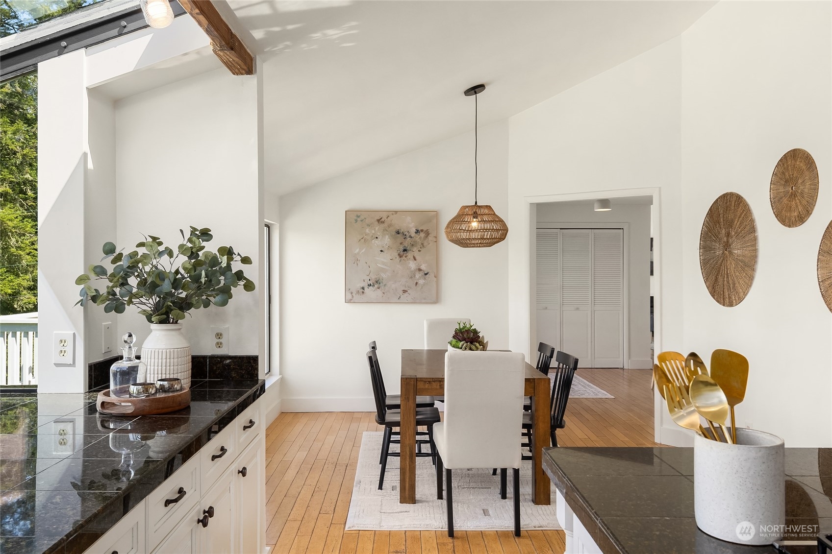 6024 Rose Loop Northeast Bainbridge Island, WA 98110 - Photo 8 of 40 a view of a dining room with furniture and potted plant