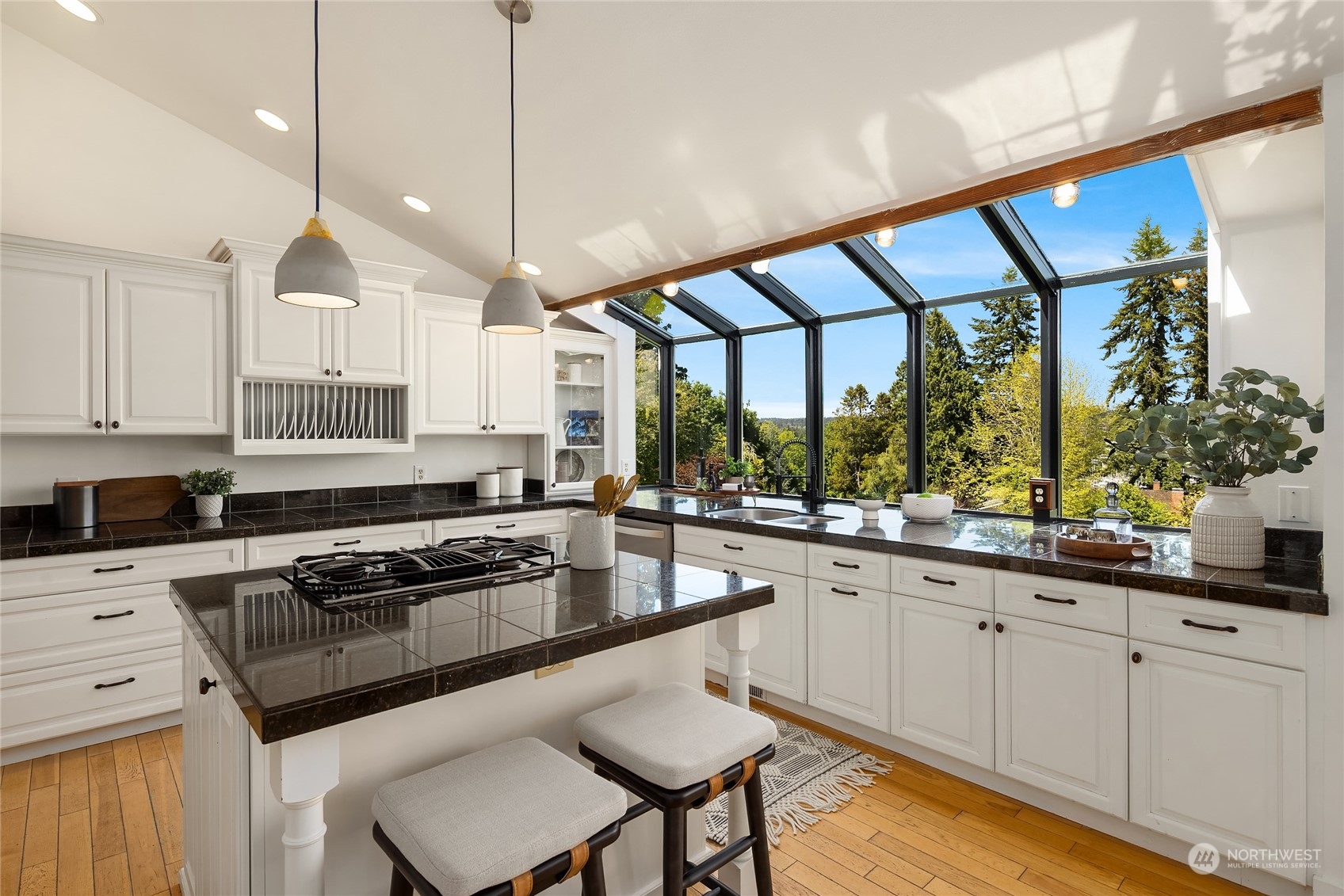 6024 Rose Loop Northeast Bainbridge Island, WA 98110 - Photo 9 of 40 a kitchen with a stove a sink a center island and wooden floor