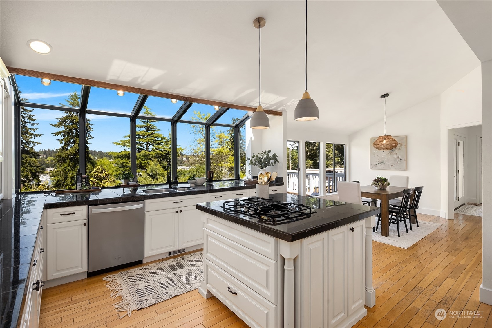 6024 Rose Loop Northeast Bainbridge Island, WA 98110 - Photo 10 of 40 a kitchen with stainless steel appliances granite countertop a stove a sink and a wooden floor