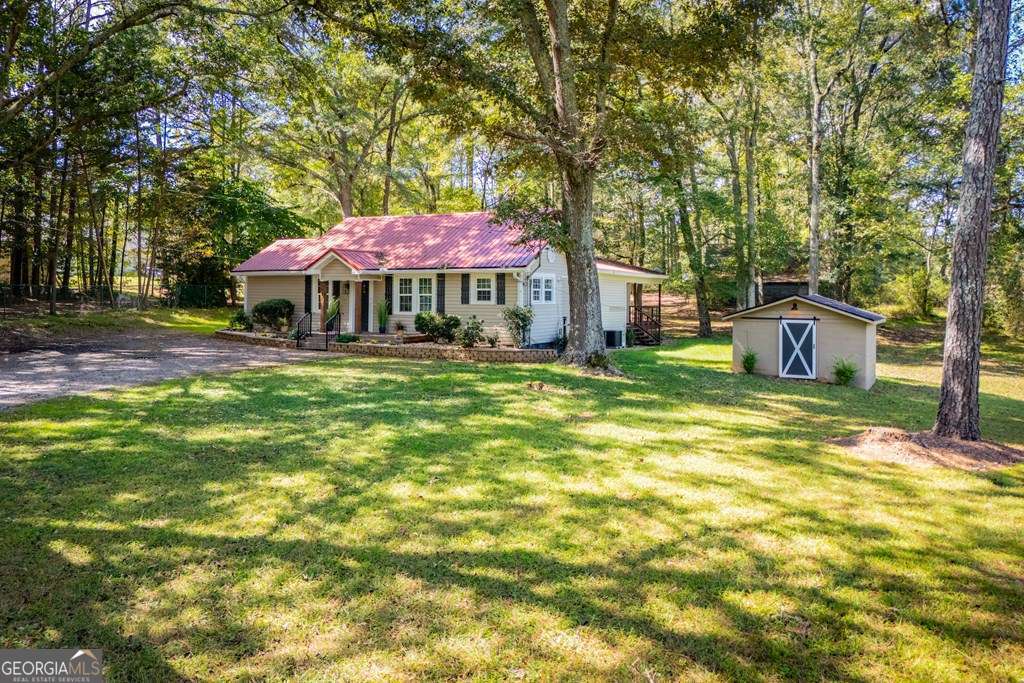 a view of a house with a yard porch and sitting area