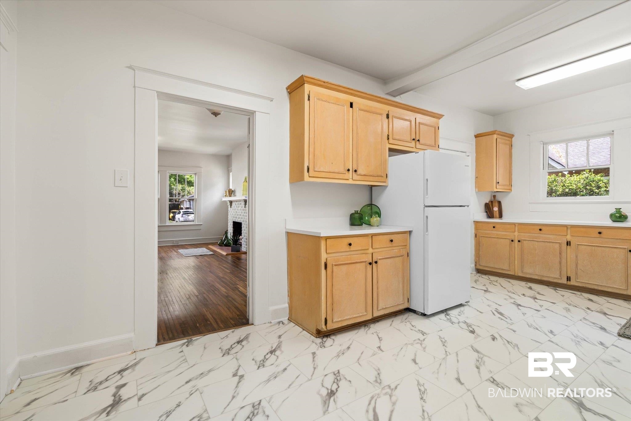 121 Westwood Street Mobile, AL 36606 - Photo 8 of 20 Kitchen featuring marble finish floor, a wealth of natural light, light countertops, and freestanding refrigerator