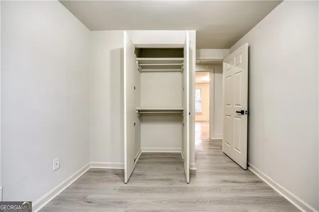 a view of an empty room and wooden floor