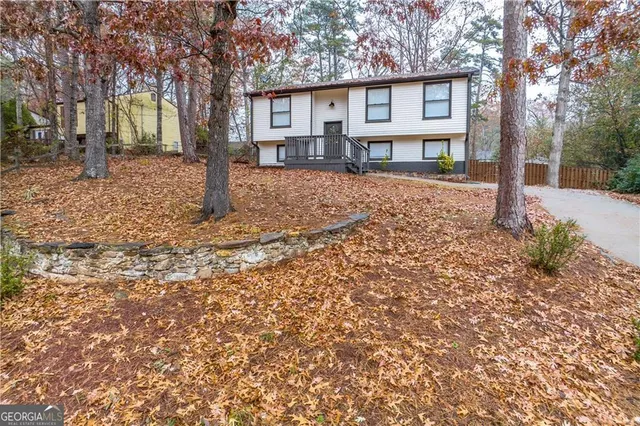 a front view of a house with a yard covered in snow
