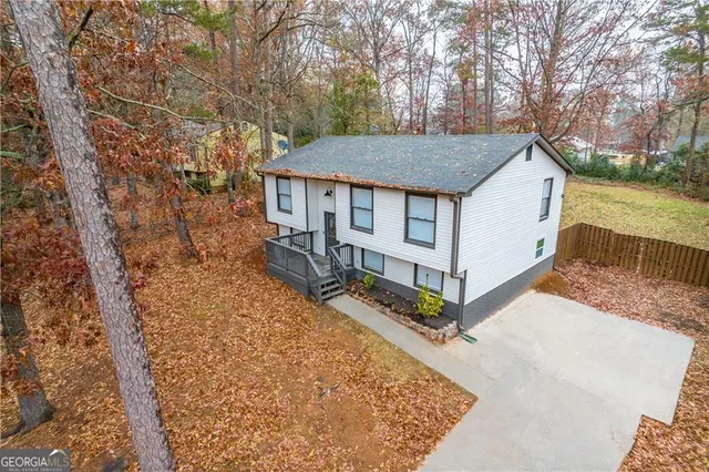 a backyard of a house with large trees