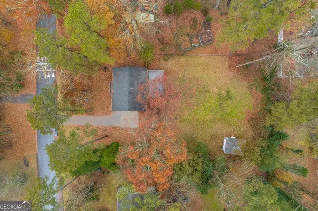 a aerial view of a house with a yard and large tree