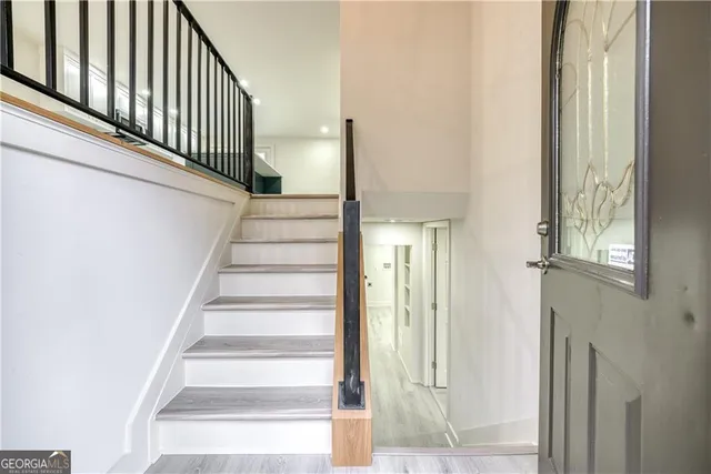 a view of staircase with white walls and windows