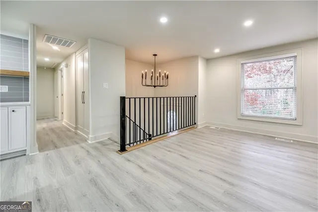 a view of a hallway with wooden floor