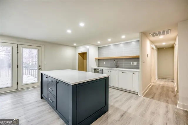 a kitchen with a stove a sink a refrigerator and a oven