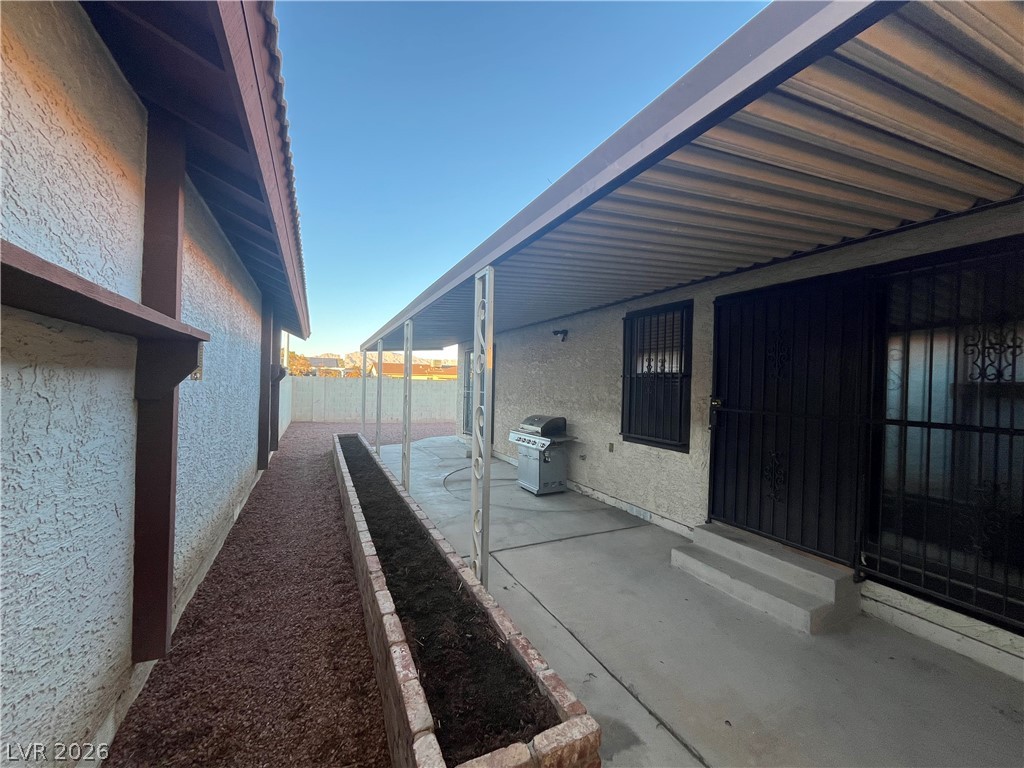 6412 West Pearcrest Road Las Vegas, NV 89108 - Photo 3 of 17 A private backyard retreat featuring a covered patio and ample space for outdoor enjoyment.