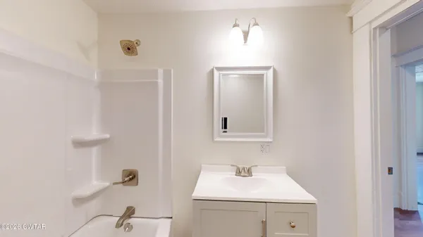 a bathroom with a sink a toilet and mirror