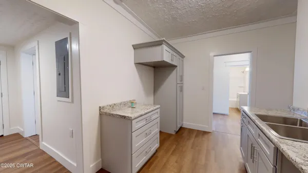 a kitchen with a sink a stove and cabinets
