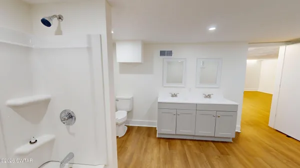 a bathroom with a tub sink and mirror