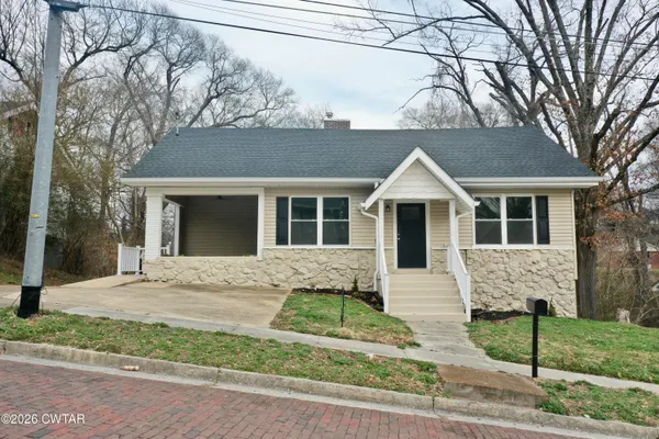 front view of a house with a yard