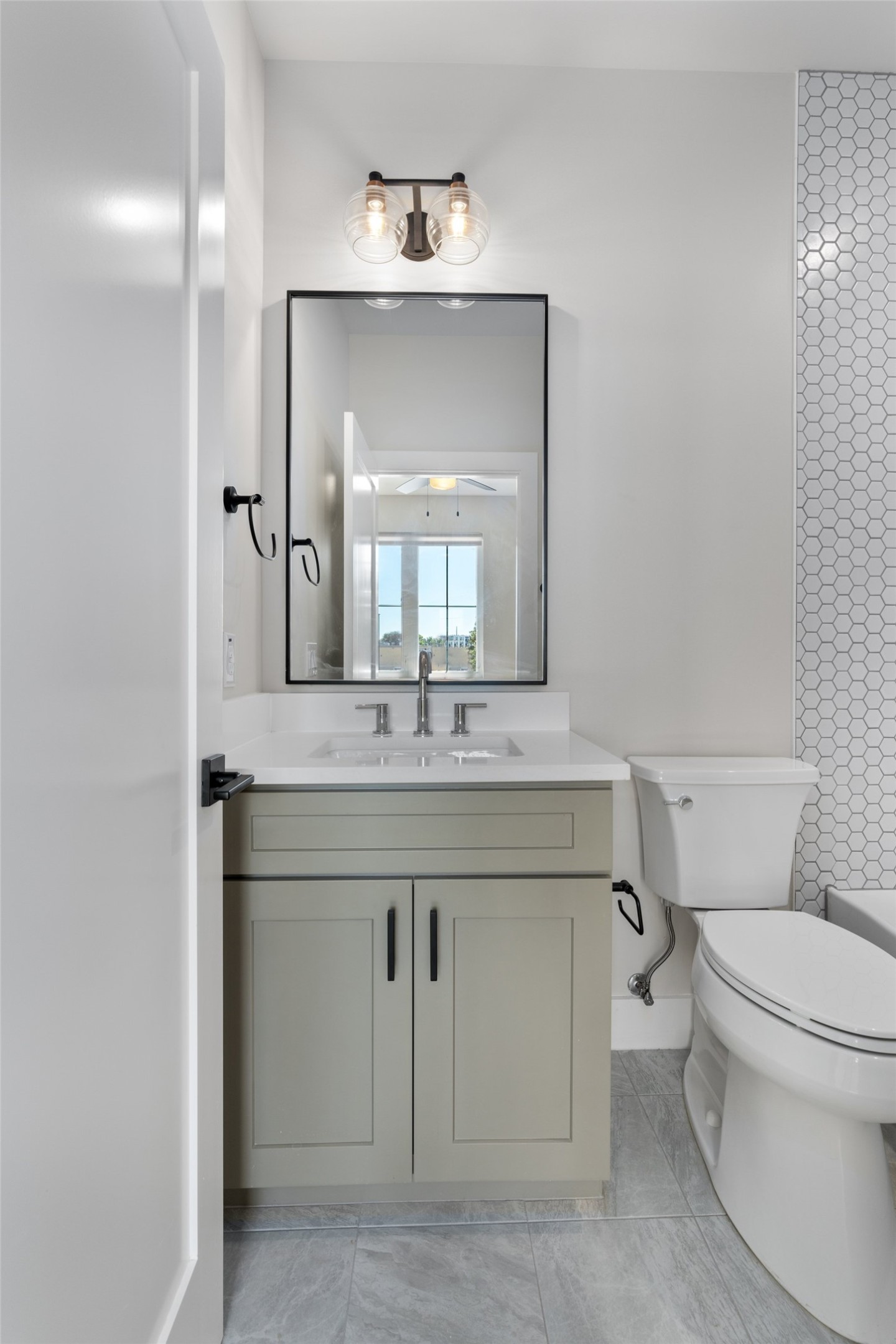 5200 Grover Avenue Austin, TX 78756 - Photo 25 of 32 Full bathroom in secondary bedroom. Vanity with shaker-style cabinetry, white quartz countertop, and a rectangular undermount sink