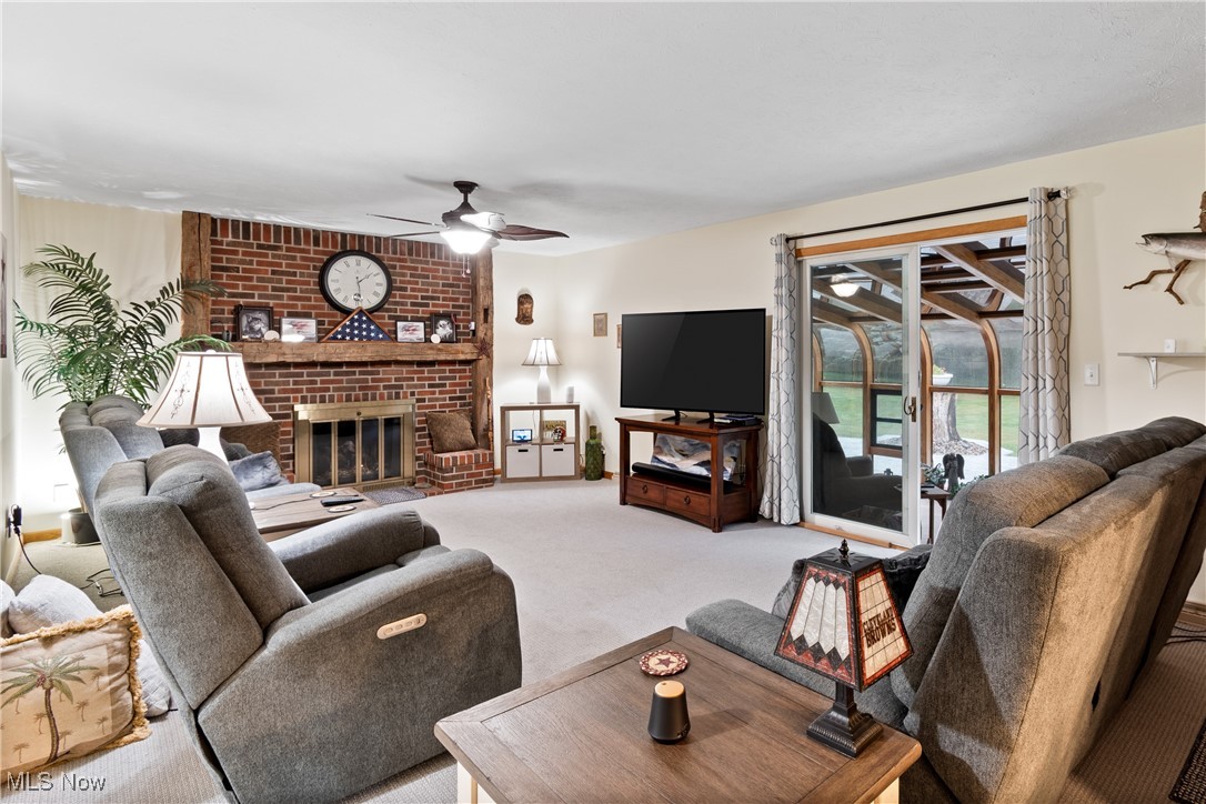 4640 Sherman Road Kent, OH 44240 - Photo 5 of 37 Living area featuring a brick fireplace, carpet, and a ceiling fan