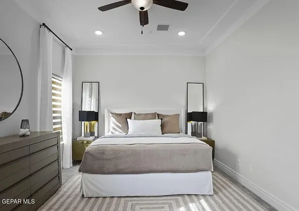 a bedroom with a large bed and a dresser