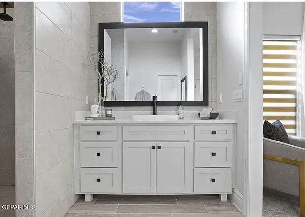 a bathroom with a double vanity sink and mirror