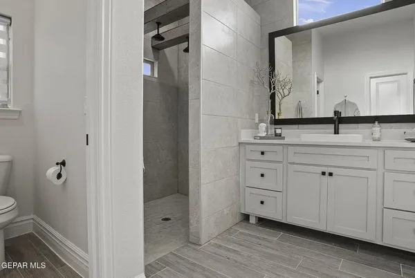 a bathroom with a double vanity sink and mirror