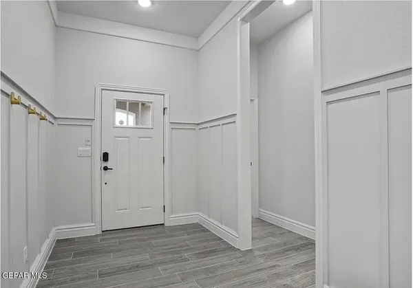 a view of an empty room with wooden floor