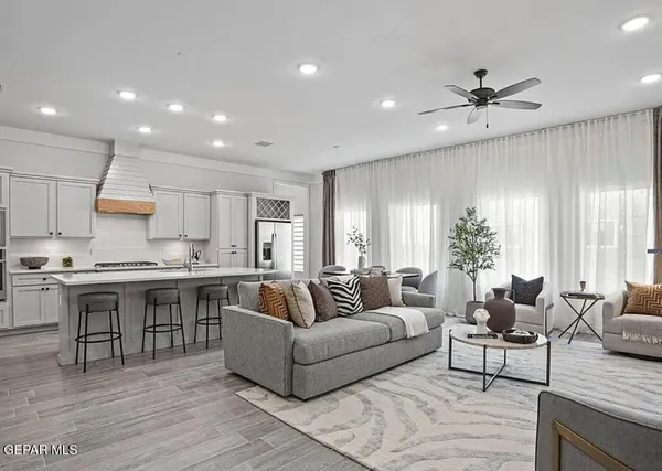 a living room with stainless steel appliances kitchen island granite countertop furniture and a couch