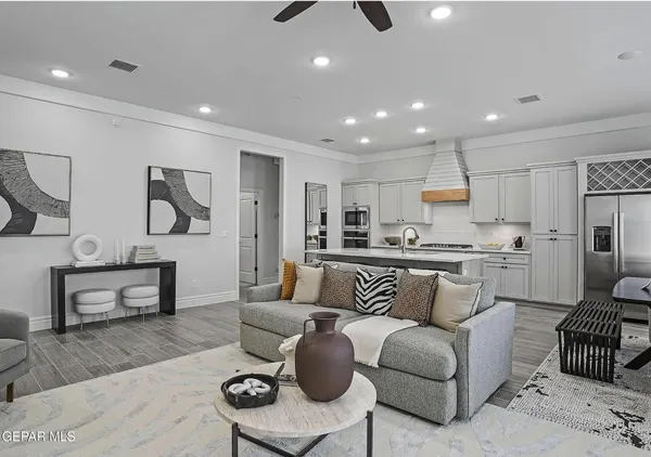 a living room with furniture and kitchen view