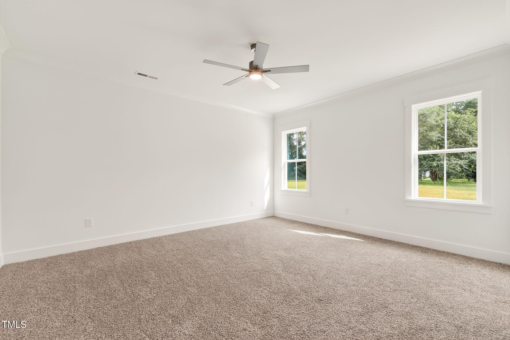 213 Maye Street Dunn, NC 28334 - Photo 22 of 45 an empty room with a window and a ceiling fan
