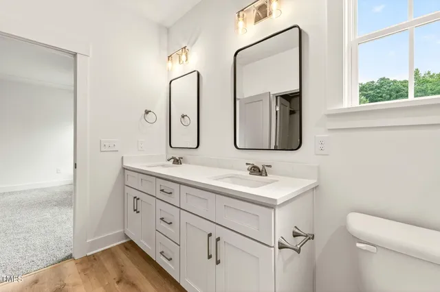 a bathroom with 2 sink and a mirror