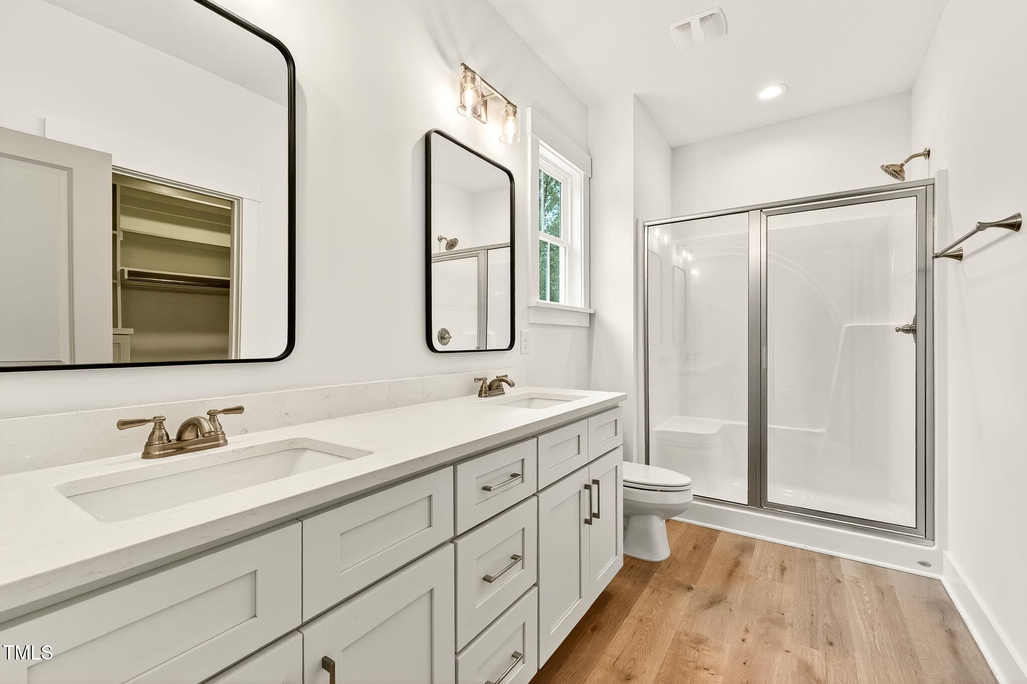 213 Maye Street Dunn, NC 28334 - Photo 25 of 45 a bathroom with double vanity sink a mirror and a shower
