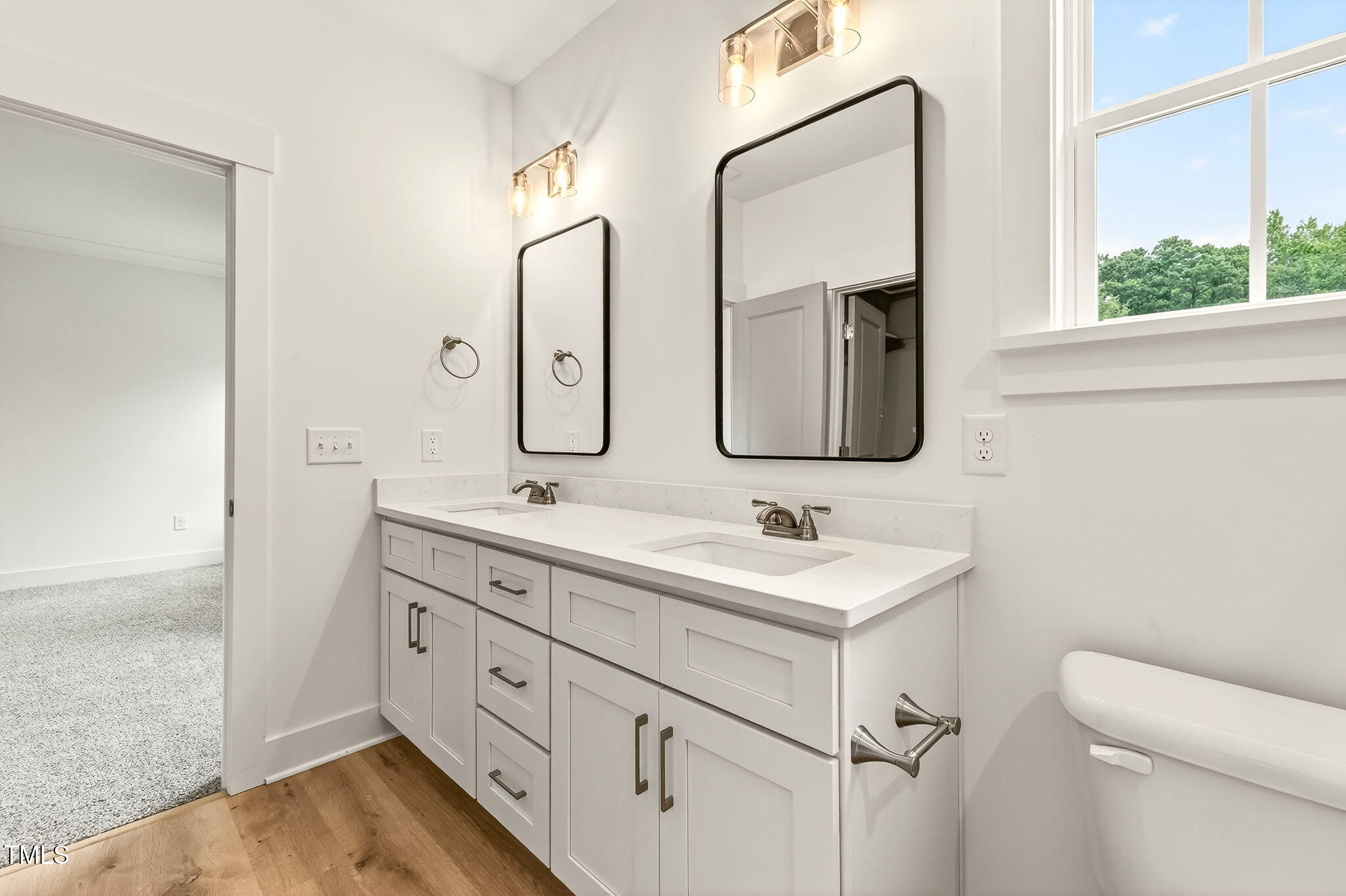 213 Maye Street Dunn, NC 28334 - Photo 26 of 45 a bathroom with 2 sink and a mirror