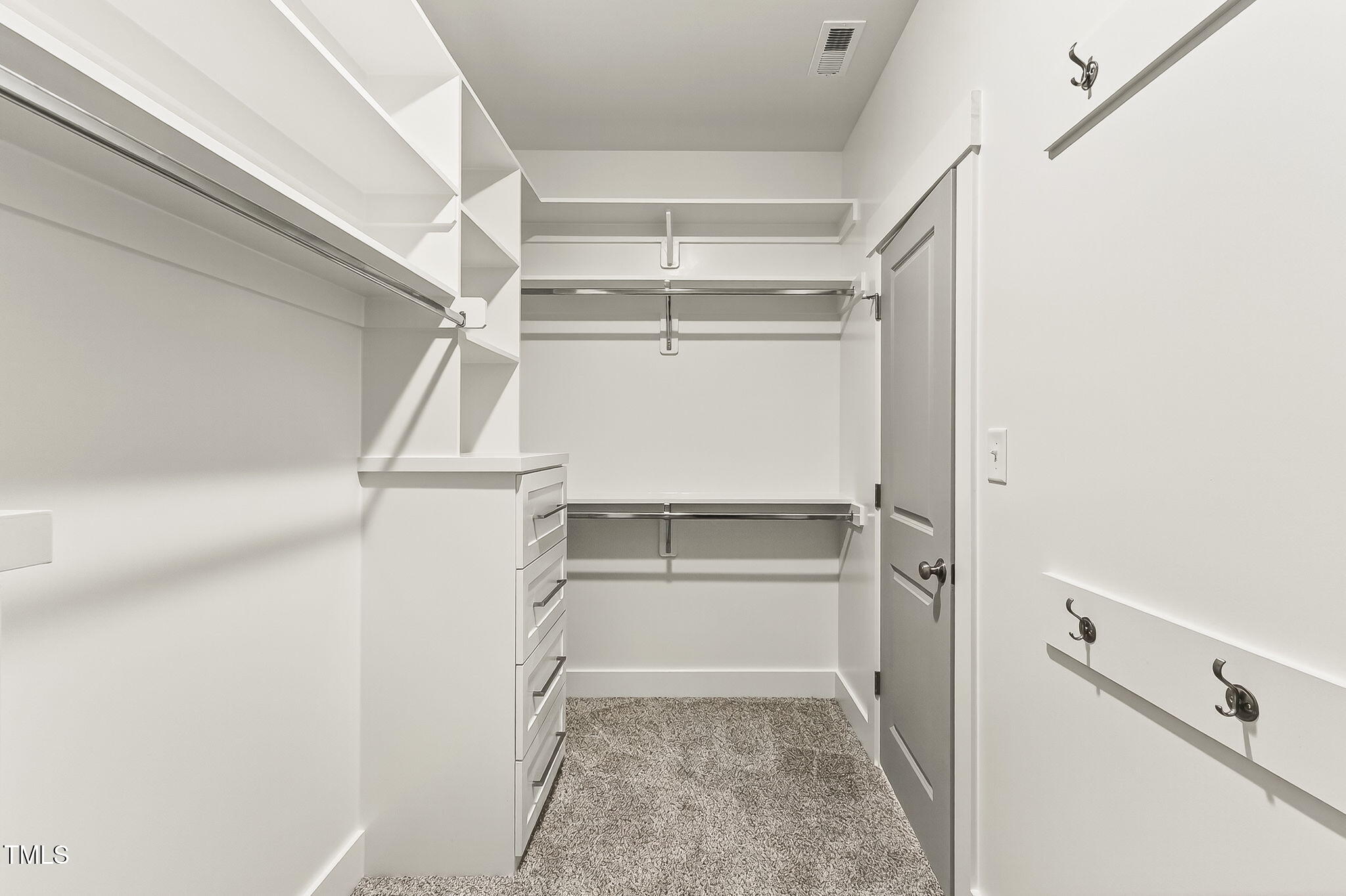 213 Maye Street Dunn, NC 28334 - Photo 29 of 45 a view of walk in closet with empty racks