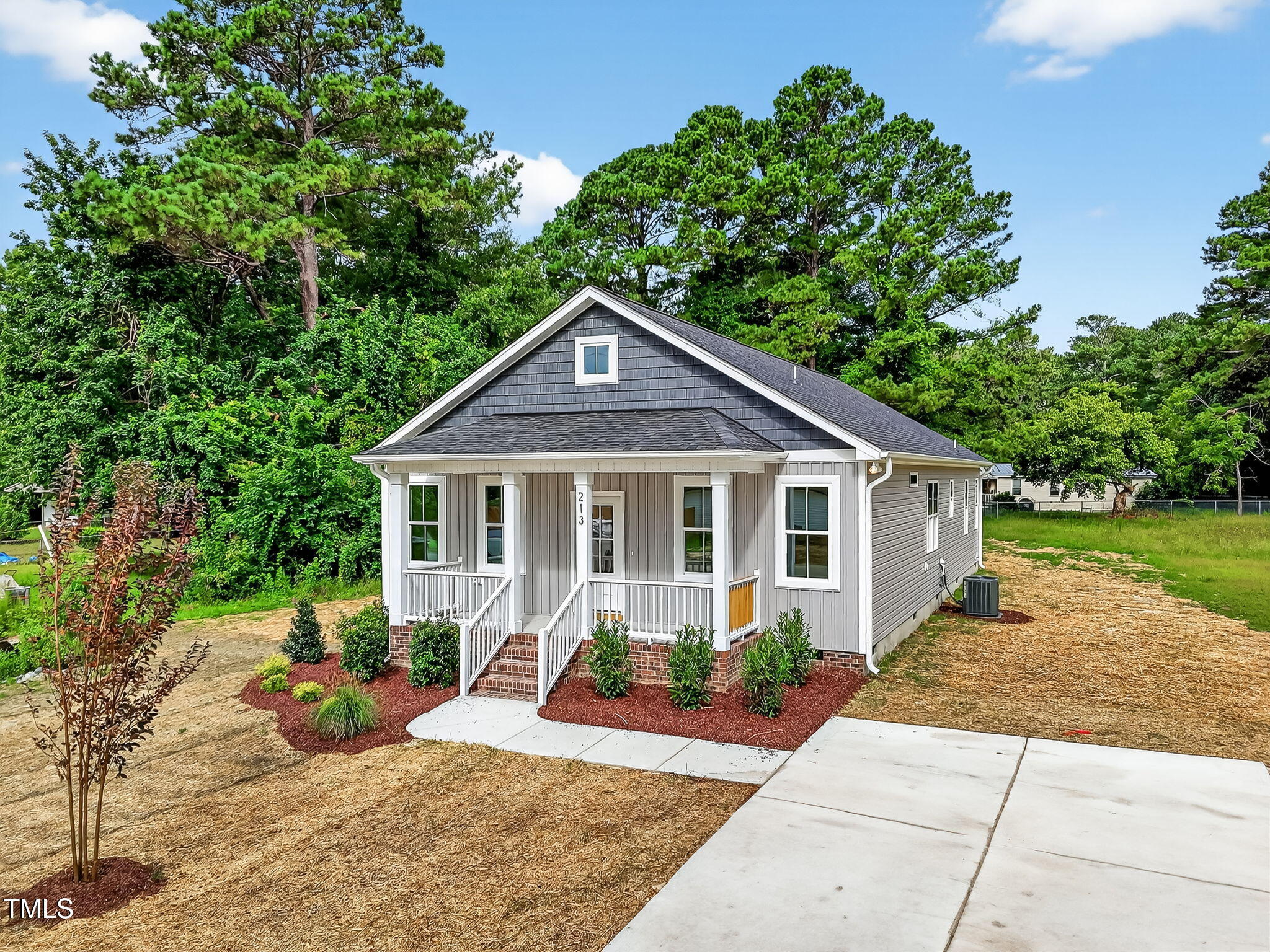 213 Maye Street Dunn, NC 28334 - Photo 45 of 45 a front view of a house with garden