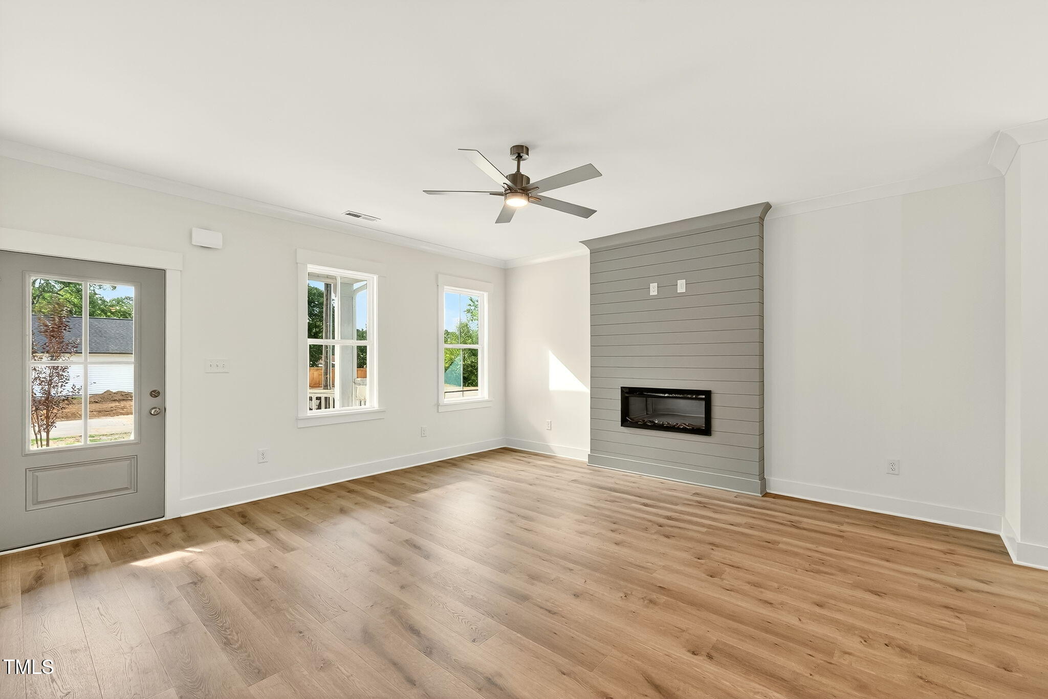 213 Maye Street Dunn, NC 28334 - Photo 10 of 45 an empty room with windows and fireplace