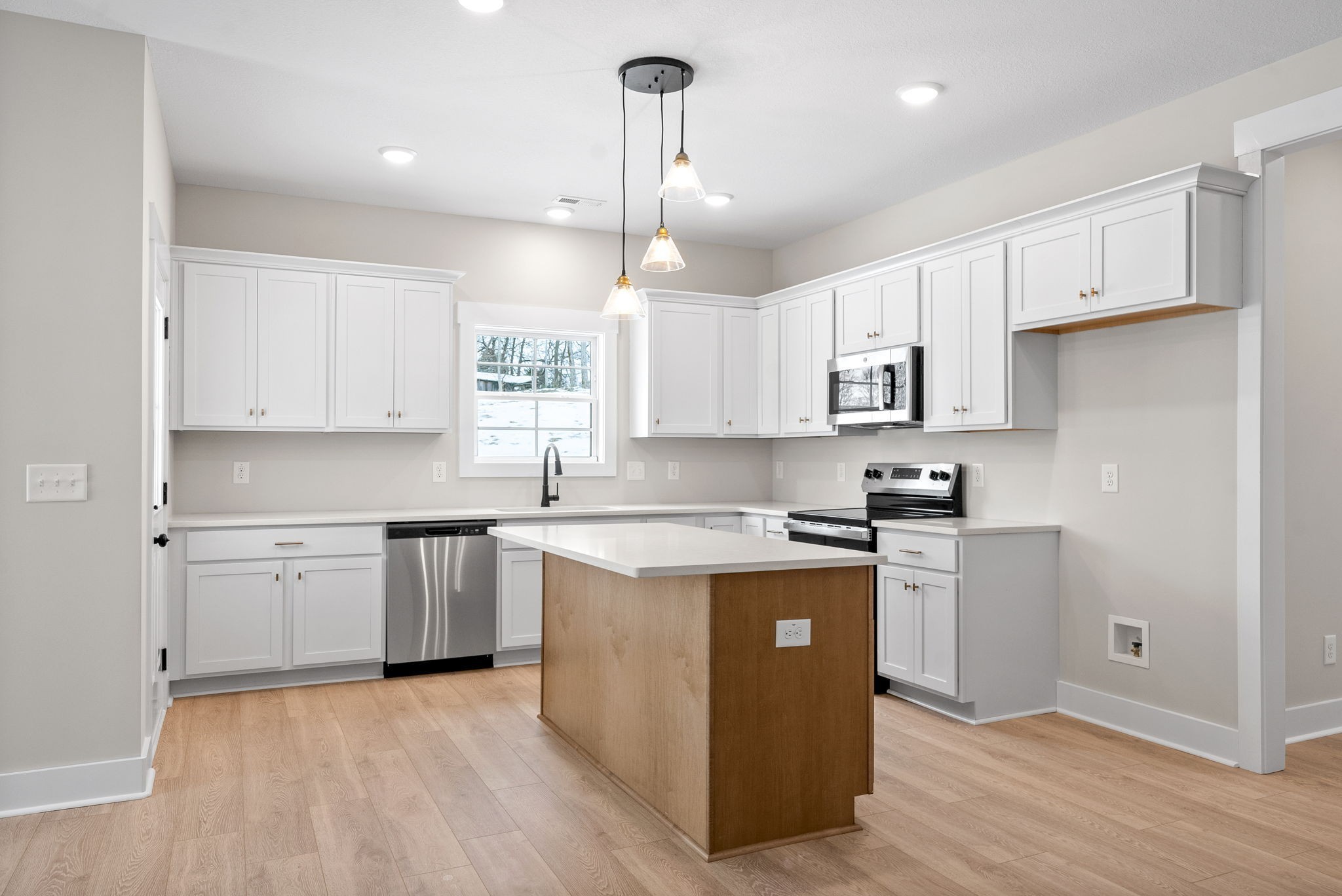 217 Wayne Hall Road Clarksville, TN 37040 - Photo 11 of 36 a kitchen with stainless steel appliances granite countertop a stove top oven a sink dishwasher and a refrigerator