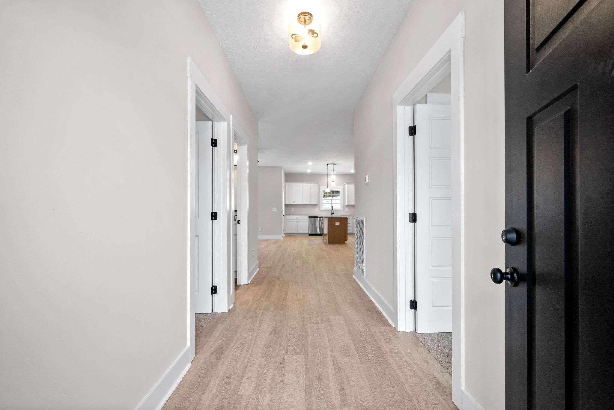 217 Wayne Hall Road Clarksville, TN 37040 - Photo 6 of 36 a view of a hallway with wooden floor a chandelier and a window
