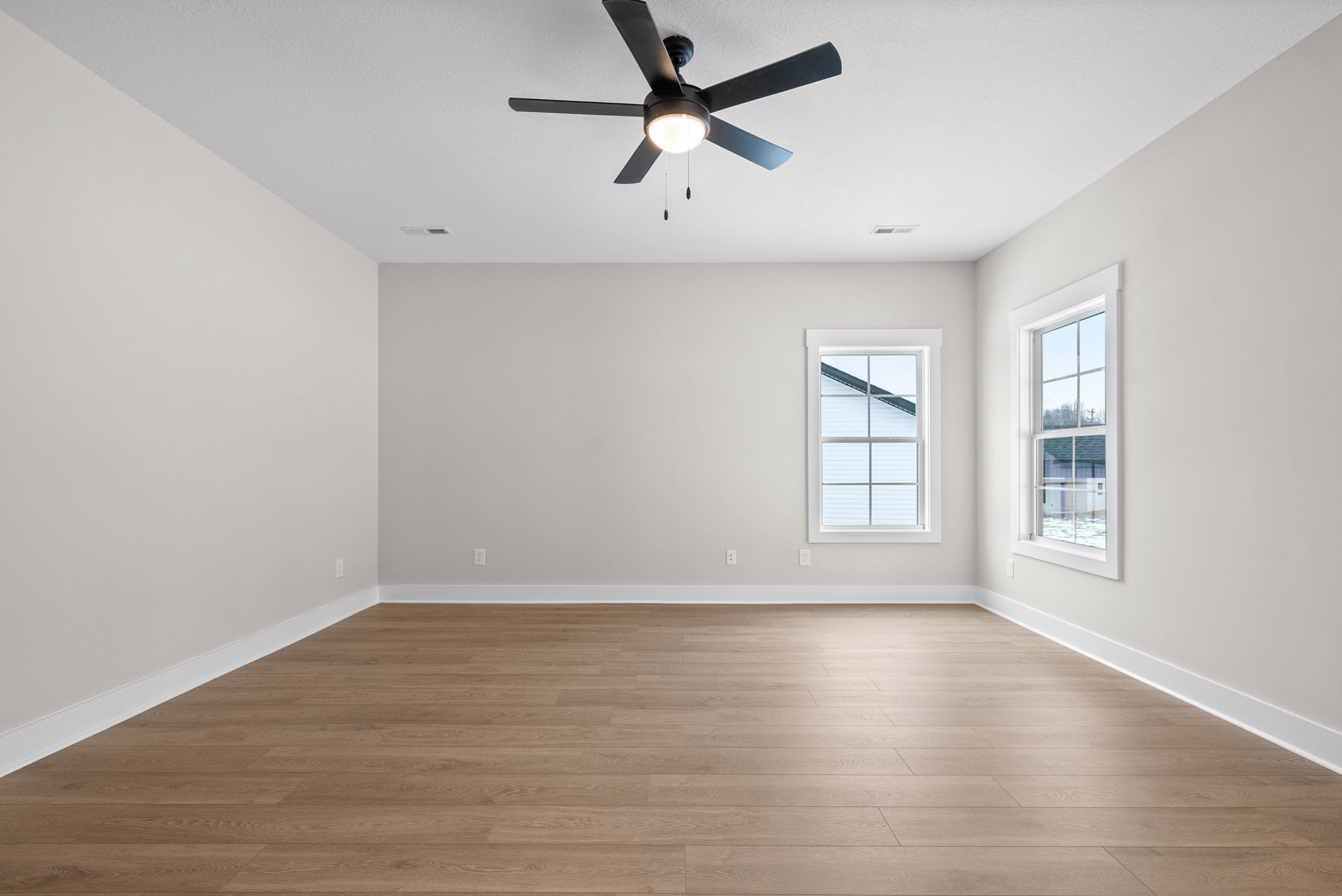 217 Wayne Hall Road Clarksville, TN 37040 - Photo 8 of 36 an empty room with wooden floor ceiling fan and windows