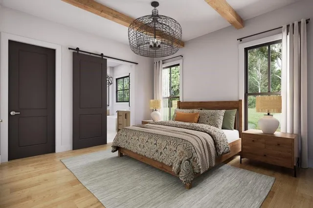 a bedroom with a large bed and a chandelier