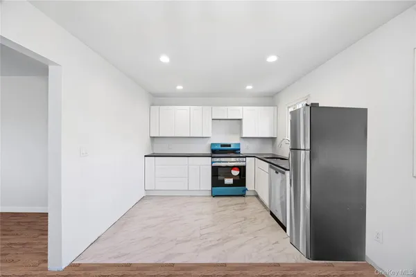 a kitchen with a refrigerator and a sink