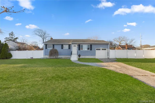 a view of an house with backyard and a tree