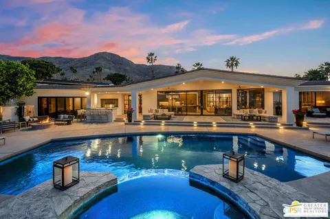 a swimming pool view with a outdoor seating