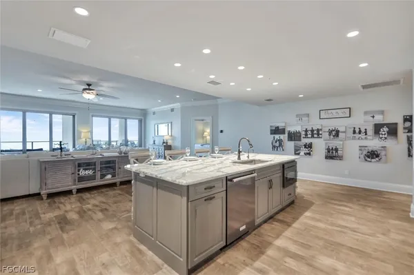 a kitchen with stainless steel appliances granite countertop a lot of counter space and wooden floor