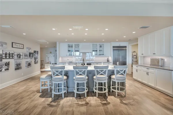 a large kitchen with a table and chairs