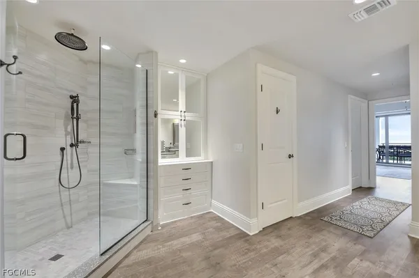 a bathroom with a shower and a sink