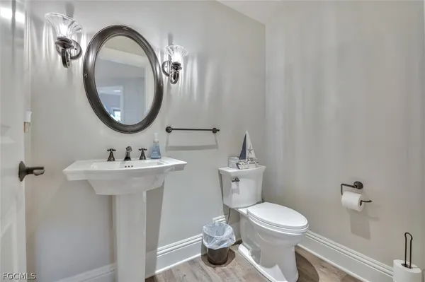 a bathroom with a toilet a sink and a mirror