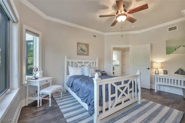 a bedroom with furniture and a wooden floor