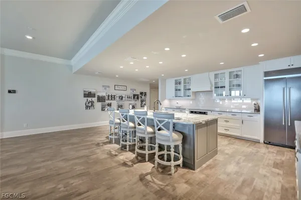 a kitchen with a sink and chairs