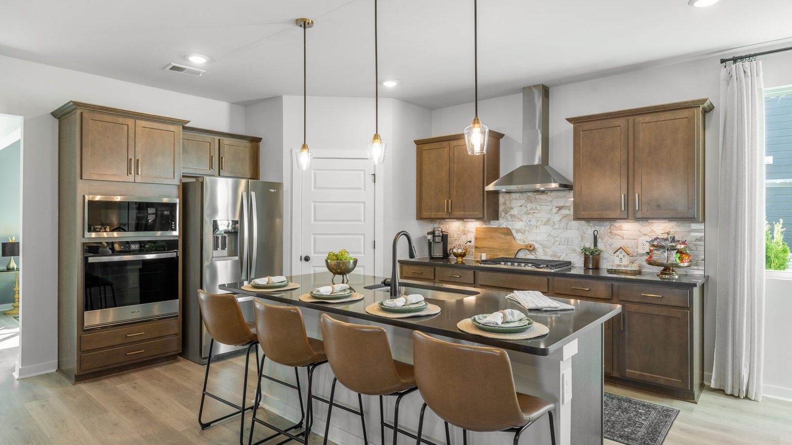305 Harvest Point Boulevard Spring Hill, TN 37174 - Photo 18 of 48 a kitchen with kitchen island granite countertop a sink stove and refrigerator