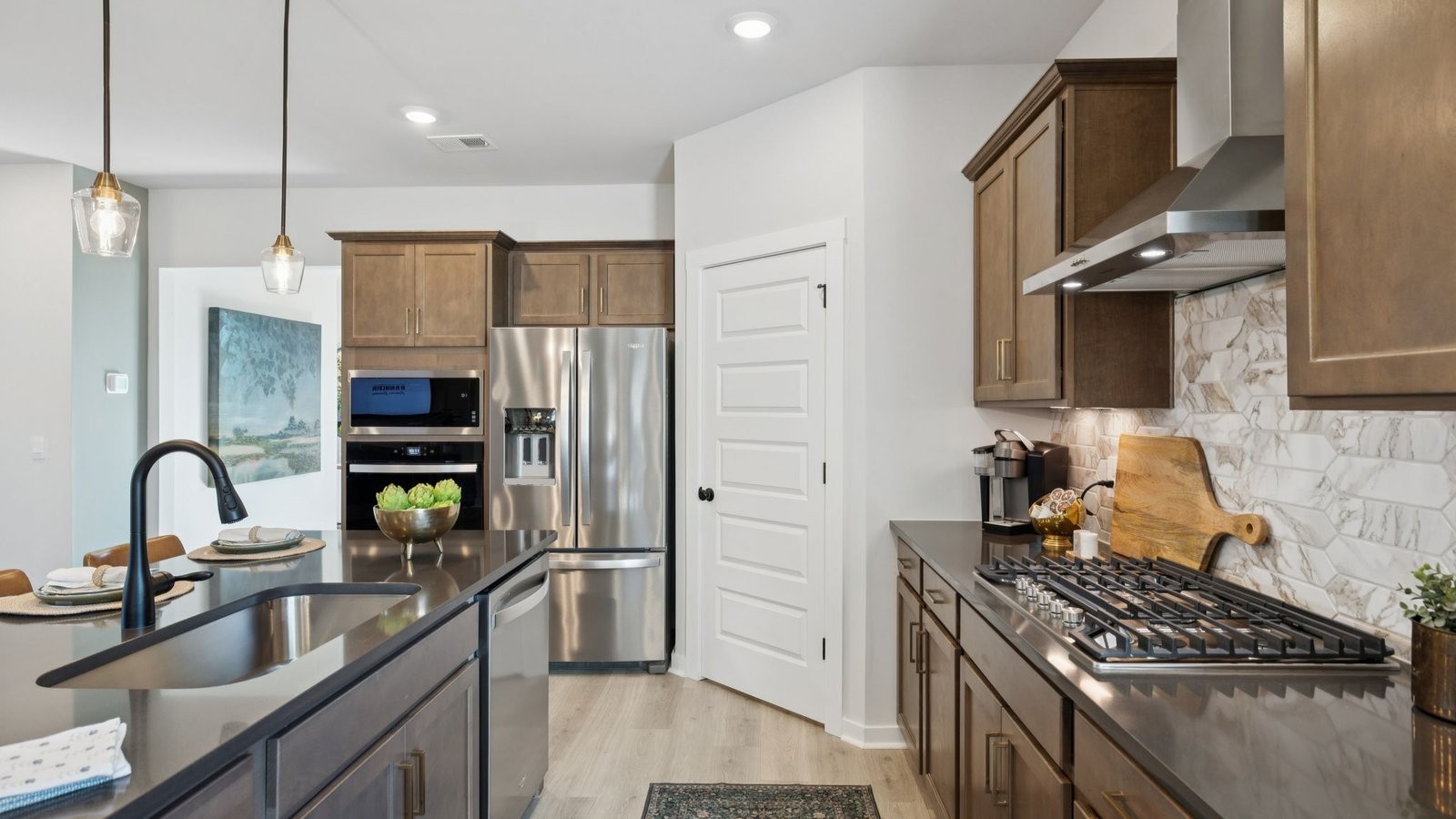 305 Harvest Point Boulevard Spring Hill, TN 37174 - Photo 19 of 48 a kitchen with granite countertop a stove a sink and a refrigerator
